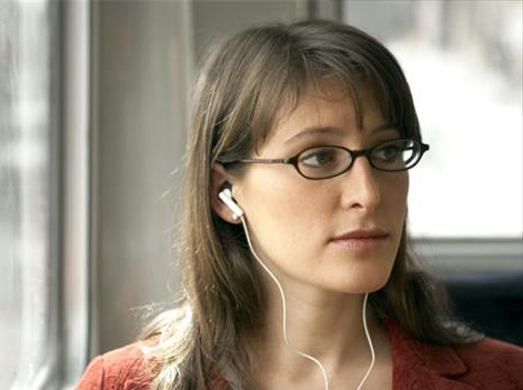 Woman Listening to Headphones on Bus